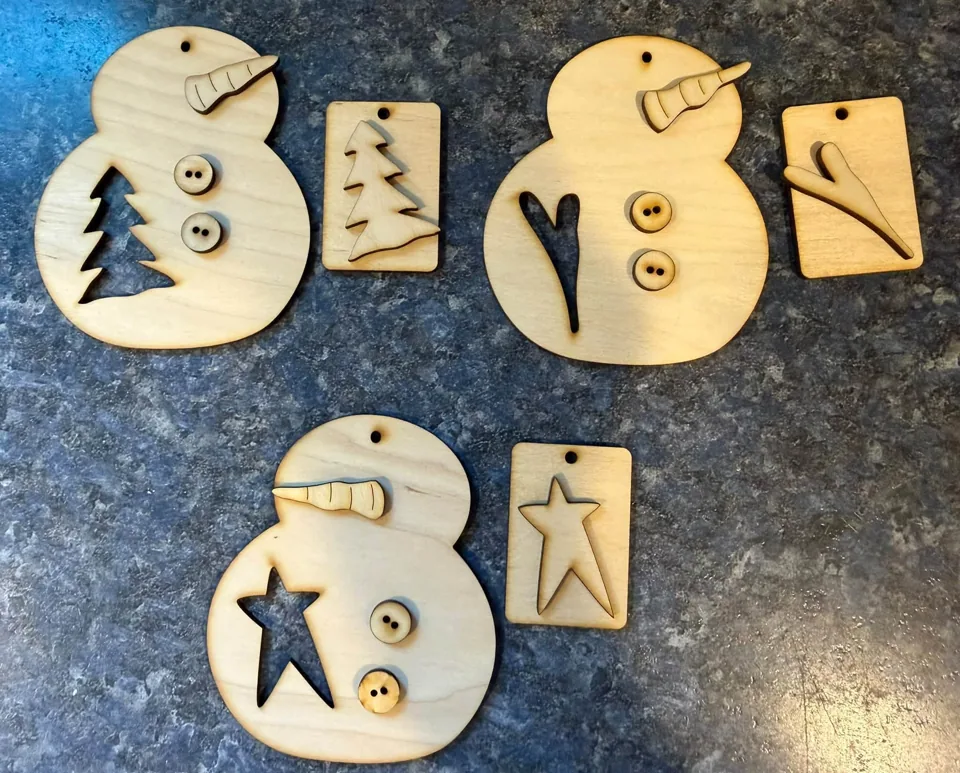 Wooden snowman shapes with star and tree details