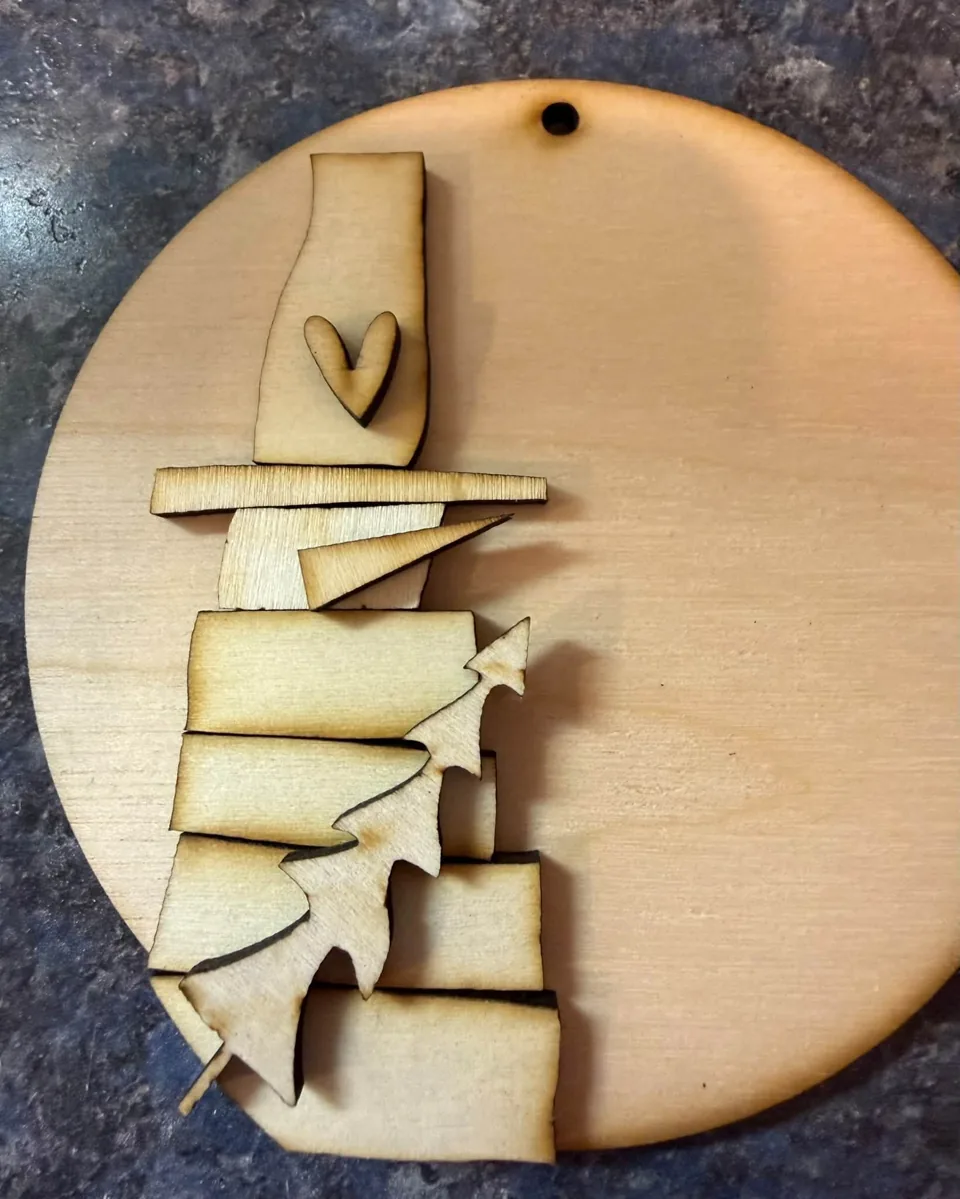 Layered wooden snowman on an arched tag