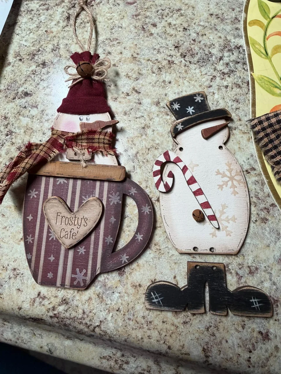Handcrafted snowmen with burgundy hats and plaid scarves