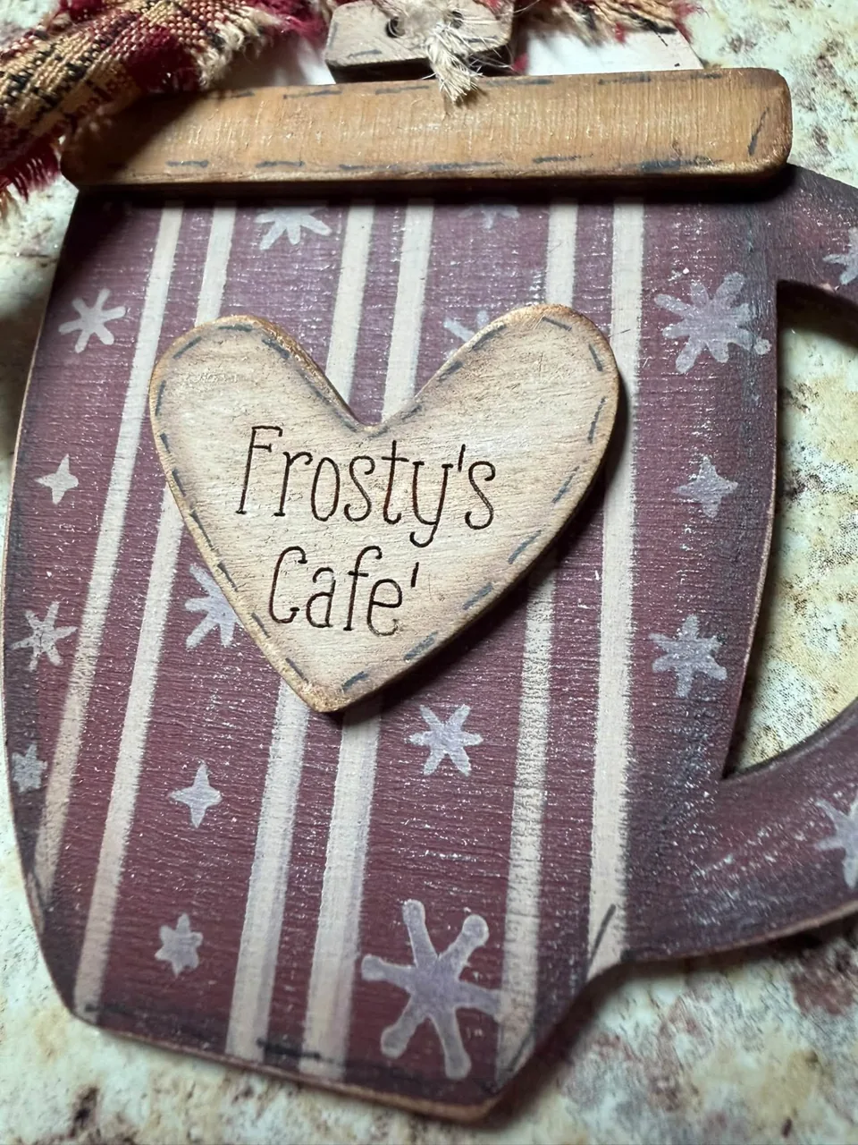 Frosty’s Cafe heart detail on a decorated wooden mug