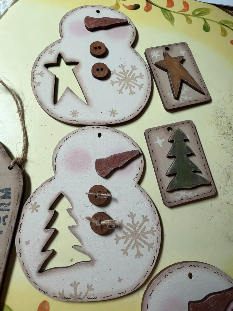 Painted wooden snowmen and tree ornaments
