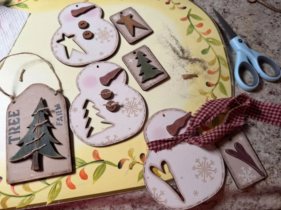 Assortment of painted Christmas tree and snowman ornaments